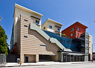 The transit-oriented entrance to MacArthur Park Apartments, with exterior stairs leading to the apartments on the top floors of the mixed-use building.